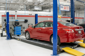 A red car in the Fabel Collision Center ready to get worked on